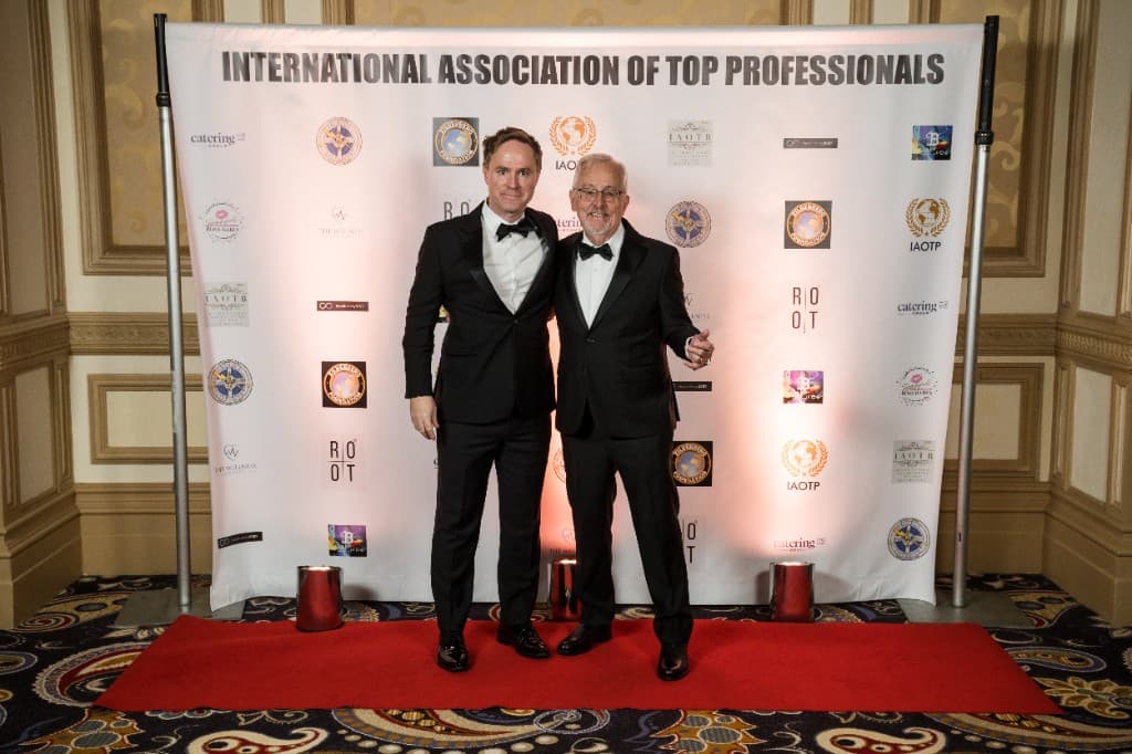 Prof. Larson with a guest in tuxedos at the IAOTP gala in Las Vegas 2025